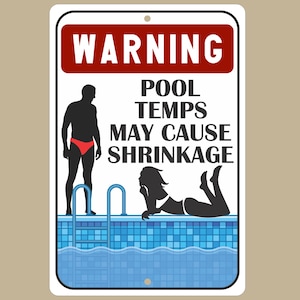 May include: A white sign with a red warning sign at the top that says "WARNING". The sign says "POOL TEMPS MAY CAUSE SHRINKAGE" in black text. There is a silhouette of a man and a woman in the image. The man is standing next to a pool ladder and the woman is lying on her stomach in a pool. The pool is blue and has white tiles.