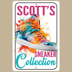 May include: A white sign with a colorful sneaker on it. The sign says "SCOTT'S SNEAKER Collection" in pink and turquoise lettering.