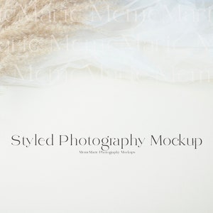 May include: A white background with a beige pampas grass plume and a white sheer fabric draped over the top. The text "Styled Photography Mockup" is centered at the bottom of the image.