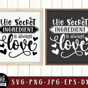 May include: Two black framed signs with white backgrounds and white text. The text on the signs reads "The Secret Ingredient is always love".