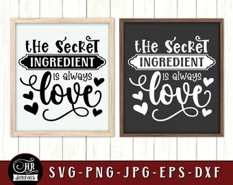 May include: Two black framed signs with white backgrounds and white text. The text on the signs reads "The Secret Ingredient is always love".