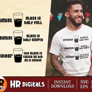 May include: A white t-shirt featuring a black and white graphic of a glass of water. The graphic depicts three different viewpoints on how full the glass is: "Optimist - glass is half full", "Pessimist - glass is half empty", and "Engineer - the glass is twice as big as it needs".