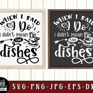 May include: Two black framed signs with white text that reads "When I said I Do, I didn't mean the dishes". The signs are on a white wood background.