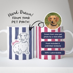 May include: White ceramic mug with a custom pet portrait. One side features a dachshund illustration with the name "Stella" and blue stripes. The other side has a photo of a dog and pink stripes. Text reads "Hand Drawn! From Your Pet Photo!"
