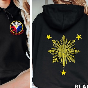 May include: Black hoodie with a yellow sun design on the back and a small Philippine flag design on the front. The text "PHILIPPINES" is below the flag.