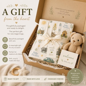 May include: A gift set for a newborn baby, presented in a cardboard box. The set includes a cream-colored blanket with animal and house illustrations, a teddy bear, and a welcome card. The blanket is tied with a cream ribbon.