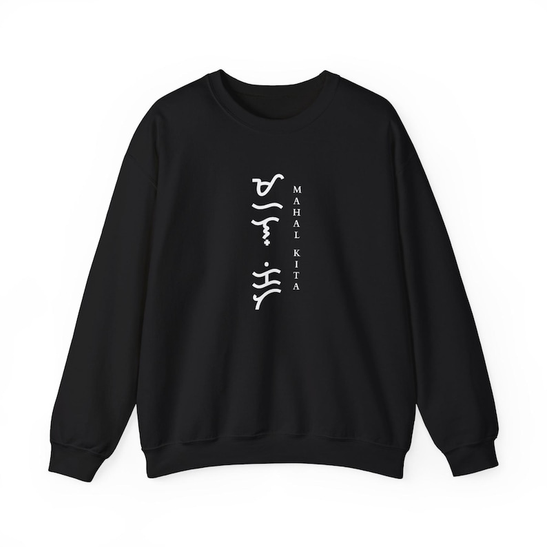 May include: A black long-sleeve sweatshirt featuring white text printed vertically in the centre. The design includes the words "MAHAL KITA" in a standard font next to a column of white Baybayin script characters.