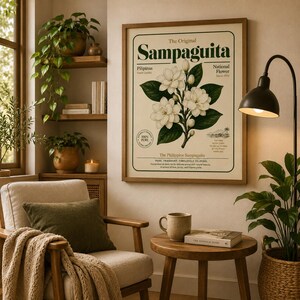 May include: A framed botanical wall art print featuring a central illustration of white Sampaguita flowers with green leaves. The text reads The Original Sampaguita, Pilipinas National Flower, and The Philippine Sampaguita on a cream background.