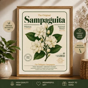 May include: A framed botanical art print featuring a central illustration of white Sampaguita flowers with green leaves. The text reads The Original Sampaguita, Pilipinas, National Flower, Since 1934, 100% Pure, and The Philippine Sampaguita.