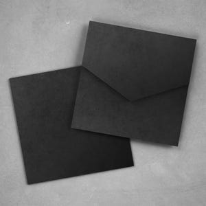 Op de afbeelding: Twee zwarte vierkante enveloppen liggen op een grijze ondergrond. Eén envelop is open en toont een driehoekige flap. De andere envelop is gesloten. De enveloppen hebben een textuur.