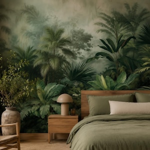 May include: A bedroom featuring a large wall mural of a lush green tropical jungle with palm trees and ferns. The room includes a wooden bed frame with olive green bedding, a wooden nightstand with a beige lamp, and a wooden chair with a white throw.