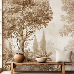 May include: A rectangular wooden bench with a natural finish sits in front of a wall mural featuring a sepia-toned landscape with trees and foliage. On the bench are a round brown ceramic pot, a small beige bowl, and a plain light beige pillow.