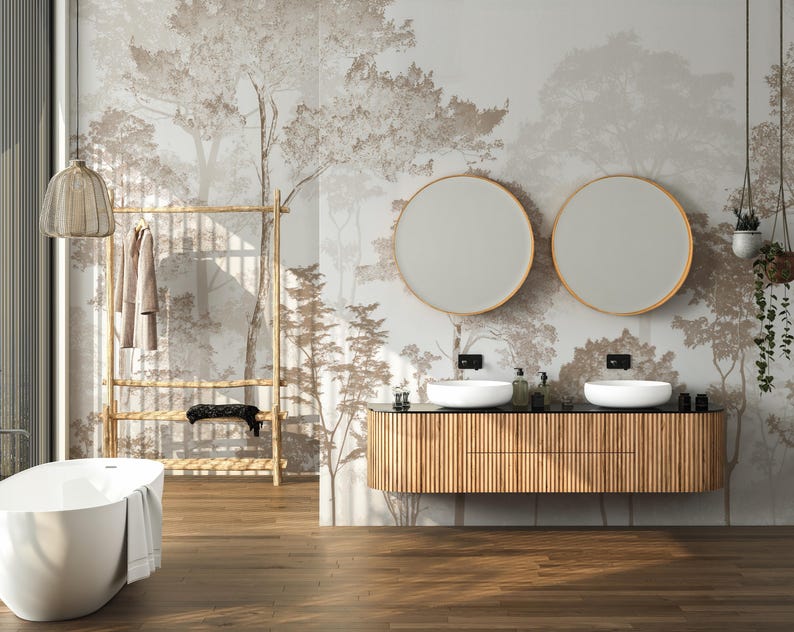 May include: A modern bathroom with a freestanding white bathtub, a wooden vanity with two round mirrors, and a bamboo clothing rack. The walls feature a forest-themed mural in neutral tones, creating a serene and natural ambiance.