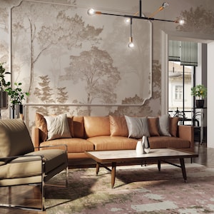 May include: A tan leather sofa with light grey throw pillows, a tan armchair with a chrome frame, and a rectangular coffee table with a white marble top. The room features a large wall mural of trees and a modern black metal chandelier with bulbs.