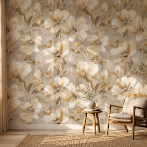 May include: Wallpaper featuring a repeating pattern of large, painterly flowers in shades of cream, beige, and soft gold against a neutral background. The floral design includes delicate petals and foliage with subtle metallic gold accents.