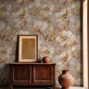 May include: A dark wooden cabinet with two doors stands against a wall covered in wallpaper featuring a large-scale floral pattern in shades of beige, cream, and gold. A framed rectangular print and two rounded clay vases sit on the cabinet top.