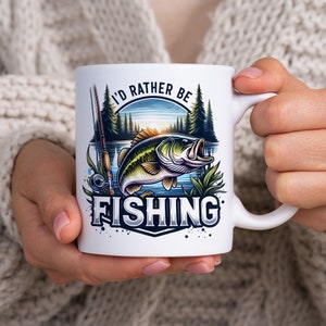 May include: White ceramic mug with a graphic of a bass fish jumping out of the water. The text "I'd rather be fishing" is printed on the mug.