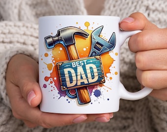 May include: White ceramic mug with a colorful watercolor design featuring a hammer, wrench, and a wooden sign that says "Best Dad".