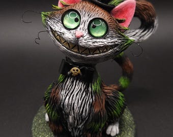 Cheshire cat, smiling, colourful, funny fantasy cat figurine, sculpture