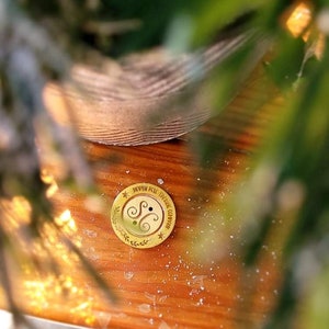 May include: A gold-colored metal disc with the text "North Pole Trading Company" and a stylized double-S logo.