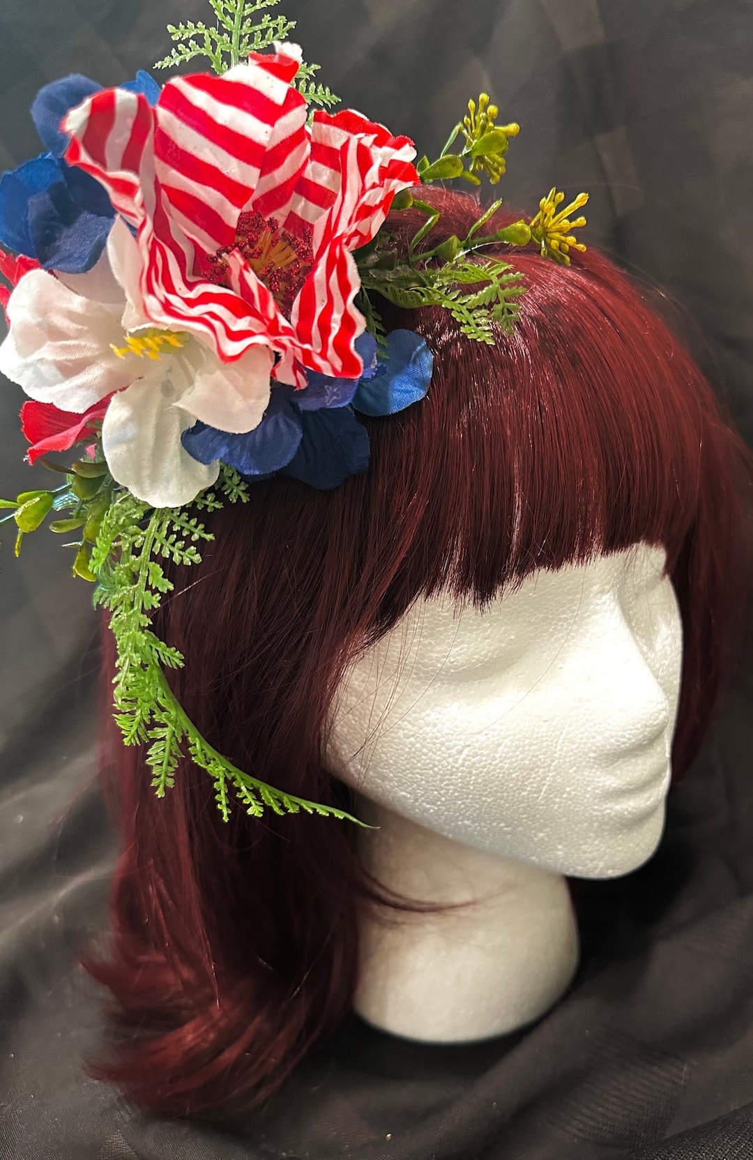 Fourth of July hair clip featuring red, white, and blue flowers in a tiki-inspired design