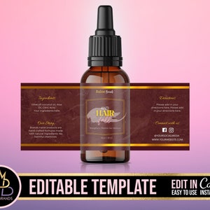 May include: A brown glass bottle with a gold label that says "Anti Hair Fall" and has a dropper top. The label also includes ingredients, directions, and contact information. The bottle is sitting on a pink background.