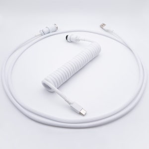 May include: A white coiled keyboard cable with a USB-A connector on one end and a USB-C connector on the other. The cable has a detachable connector in the middle and is designed for mechanical keyboards.