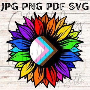 Puede incluir: Un girasol arcoíris con una bandera del orgullo transgénero en el centro. El girasol tiene pétalos en los colores del arcoíris, rojo, naranja, amarillo, verde, azul, índigo y violeta. La bandera del orgullo transgénero es blanca, azul claro, rosa y marrón.