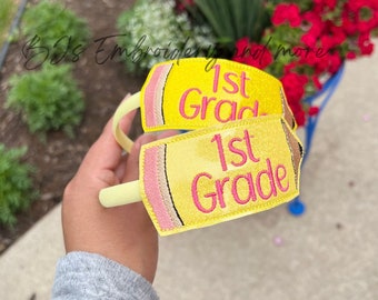 May include: Two yellow pencil-shaped headbands with pink accents. The headbands have the text "1st Grade" embroidered on them.