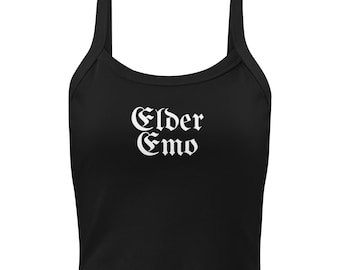 May include: Black crop top with wide straps. The text "Elder Emo" is printed in white gothic lettering across the front. The top is a solid black colour.