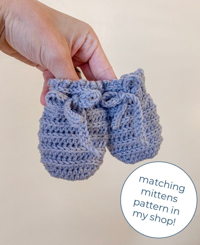 May include: A pair of gray crocheted baby mittens with a tied bow detail. Matching mittens pattern in my shop!