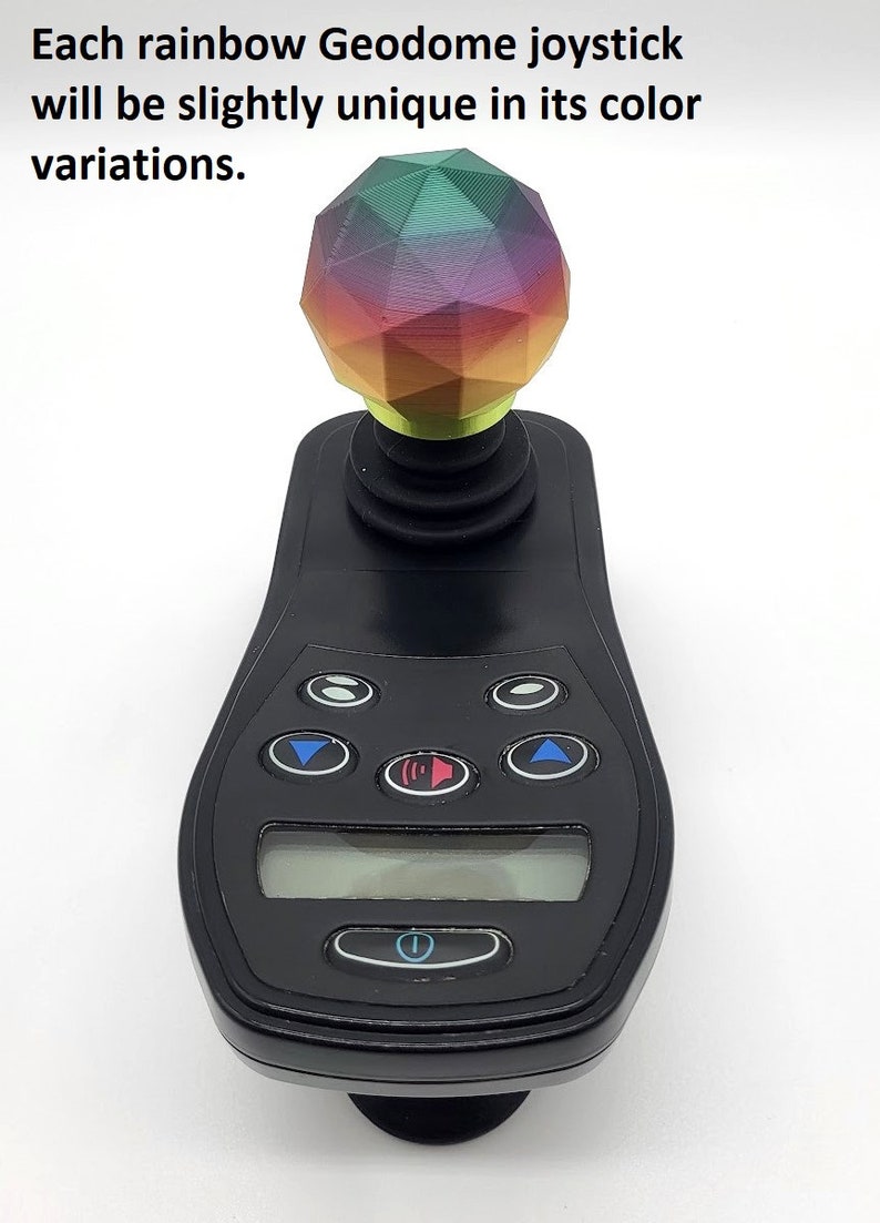 May include: A black joystick with a rainbow coloured geodome top. The joystick has a digital display and several buttons.