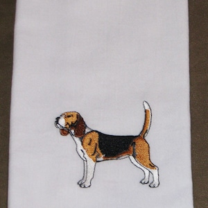 May include: White kitchen towel with an embroidered image of a brown and white beagle dog.