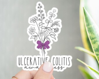 Op de afbeelding: Een witte sticker met een zwarte lijntekening van een boeket bloemen gebonden met een paars lint. De tekst "Ulcerative Colitis Awareness" staat onder de bloemen.