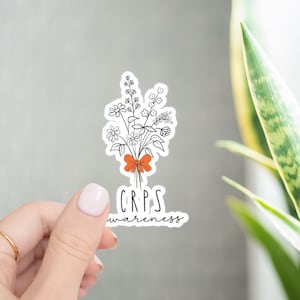 May include: White sticker with a black line drawing of a bouquet of flowers tied with an orange ribbon. The text "CRPS awareness" is below the flowers.