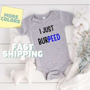 May include: Gray baby onesie with the text "I Just Burpeed" in black and blue lettering.