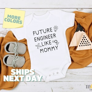 May include: White baby bodysuit with black text that reads "Future Engineer Like Mommy" with a lightbulb, ruler, and gears graphic.
