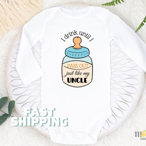 May include: White long-sleeve baby onesie with a blue and yellow baby bottle graphic and the text "I drink until I pass out just like my uncle".