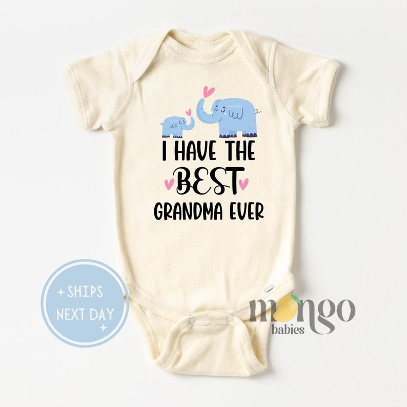 May include: A white baby onesie with short sleeves features a blue elephant and a smaller blue elephant with pink hearts above them. The text "I HAVE THE BEST GRANDMA EVER" is printed in black below the elephants.