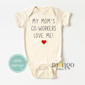 May include: A cream-colored baby onesie with the text "My Mom's Co-Workers Love Me!" in black lettering and a red heart.