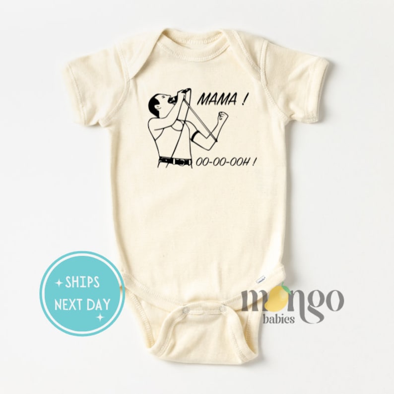 Może przedstawiać: Kremowy śpioszek dla niemowlęcia z czarno-białym rysunkiem Freddiego Mercury'ego śpiewającego z tekstem "MAMA! OO-OO-OOOH!" nadrukowanym z przodu.