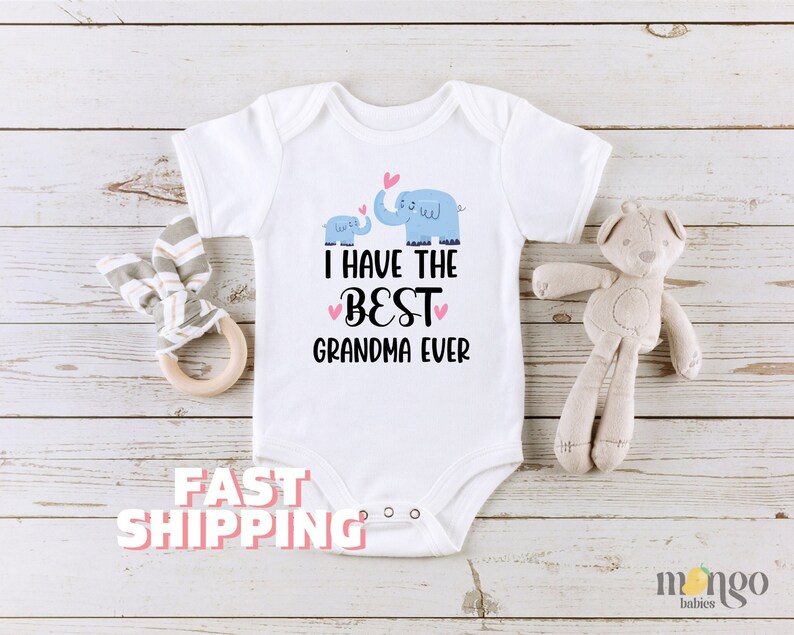 May include: White baby onesie with a blue elephant and baby elephant graphic. The text reads "I have the best grandma ever".