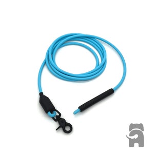 May include: A light blue dog leash with a black clasp and handle. The leash is coiled and appears to be made of a durable, flexible material. The leash is designed for pet owners.