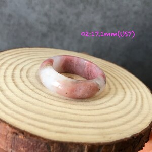 Pode incluir: Um anel de pedra polida rosa e branco. O anel tem 17,1 mm de tamanho e &eacute; um tamanho 7.