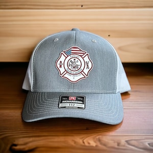 May include: Gray and white trucker hat with a red, white, and blue embroidered patch that says "Raleigh North Carolina Fire-Rescue 8". The patch features a fire hydrant, an axe, and a fireman's helmet.