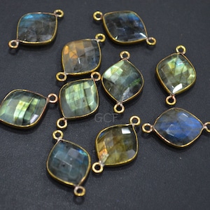May include: Ten gold-toned gemstone connectors with a faceted, square-shaped labradorite stone. Each connector has two loops for attaching to jewelry.