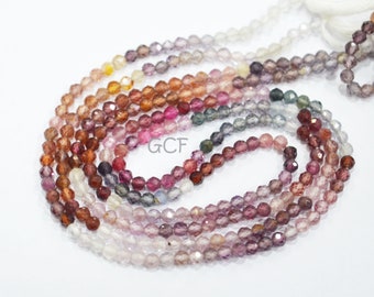 May include: A strand of faceted gemstone beads in various shades of pink, purple, blue, and brown. The beads are strung on a clear thread and are approximately 4mm in diameter.