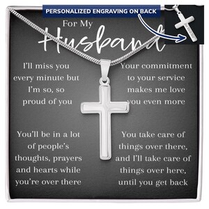 May include: A silver cross pendant necklace with a snake chain. The cross is centered on a dark grey background with text that reads "For My Husband." Additional text includes loving sentiments.