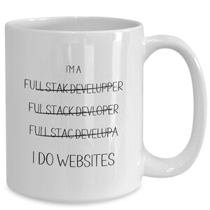 May include: White ceramic coffee mug with black text that reads "I'm a Full Stack Developer I do Websites". The words "Full Stack Developer" are crossed out.