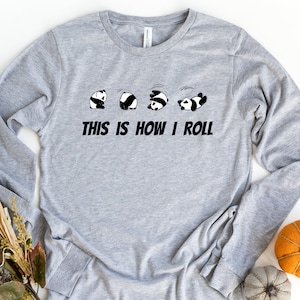 May include: Gray long-sleeve shirt with a graphic of five pandas rolling, and the text "This is how I roll".